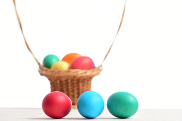 colorful easter eggs in basket isolated on white