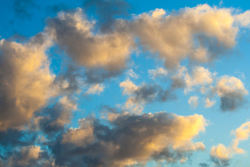 Naklejka na ściany i meble Golden clouds on blue sky background