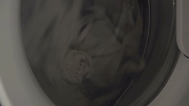 Washing machine with front loader doing laundry