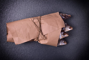 withered in salt and dried fish roach wrapped in brown kraft paper