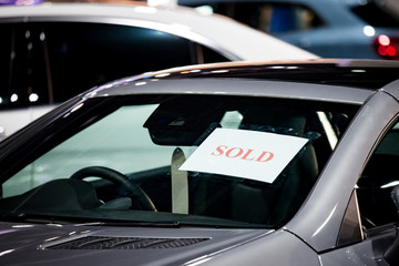 Selective focus sold label of car in parking at show room