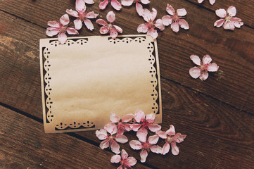 Note, postcard, writing of peach tree flowers on a wooden vintage table