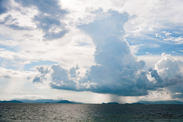 Naklejka na ściany i meble A large dark tall rain cloud over the sea