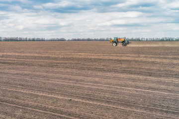  Tractor preparing the field before seeding the ground. Wheat - main crops, which are grown in Ukraine