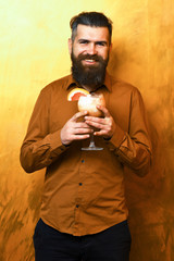 Brutal caucasian hipster holding tropical alcoholic fresh cocktail