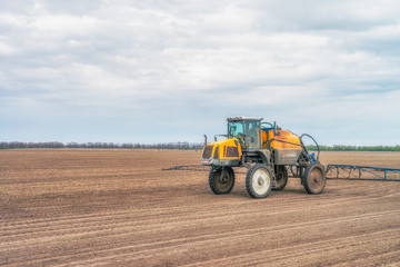  Tractor preparing the field before seeding the ground. Wheat - main crops, which are grown in Ukraine