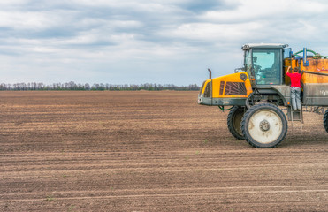  Tractor preparing the field before seeding the ground. Wheat - main crops, which are grown in Ukraine