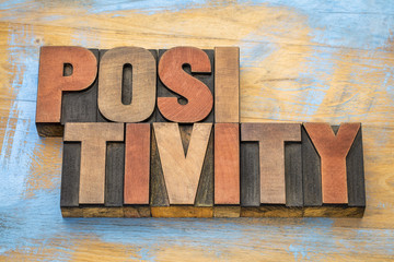 positivity word abstract in wood type