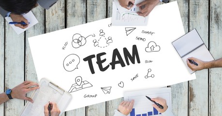 Team text by icons and business people on table