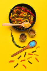 Colorful dried fusilli pasta with salt and spices