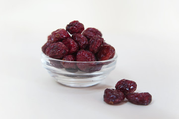 Horizontal shot of a bowl of cranberries on a white background