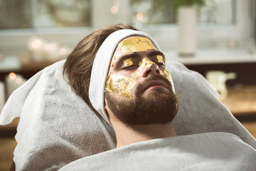 Men's gold mask therapy at beautician's