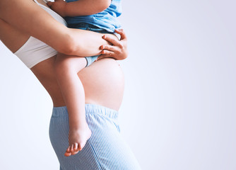 Pregnant mother and son at home.