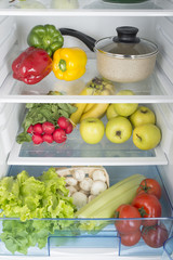 Open fridge full of fresh fruits and vegetables