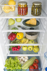 Open fridge full of fresh fruits and vegetables