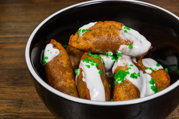  Fried Ravioli with Sauce on a wooden background.