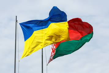 Waving flags of Ukraine and Belarus