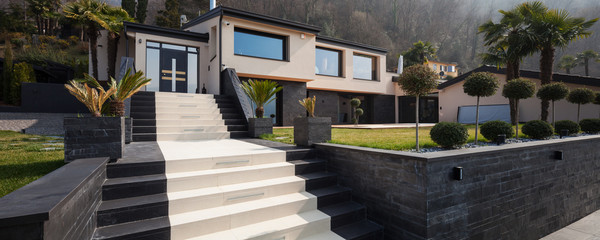 Exterior view of a modern luxury villa, staircase to the entry