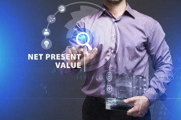 Business, Technology, Internet and network concept. Young businessman working on a virtual screen of the future and sees the inscription: Net present value