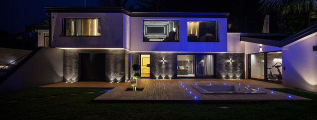 View of modern villa with pool in the night