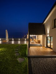 Exterior view of a modern luxury villa, nocturnal scene