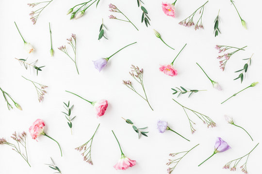 Flowers composition. Pattern made of various flowers and eucalyptus branches on white background. Flat lay, top view