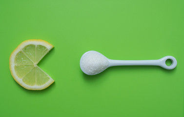 Fototapeta na wymiar Slice of lemon and a spoon with sugar