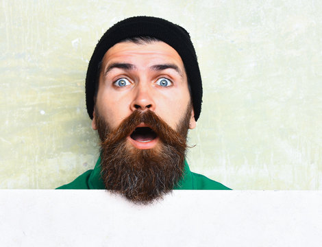 bearded man posing on studio wall background