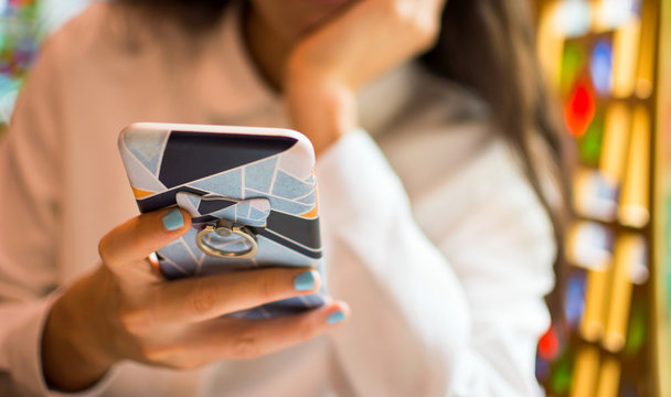 Girl using smartphone in a restaurant