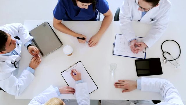 group of doctors with cardiogram at hospital