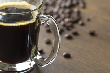 Hot black americano coffee in transparent glass cup with copy space