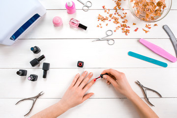 Paint your own nails. Manicure set and nail polish on wooden background