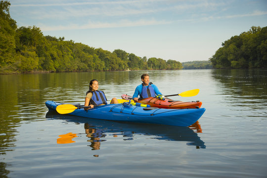 Couple kayaking in river