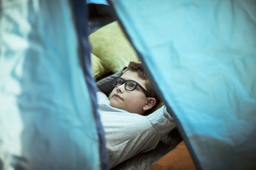 Boy lying in tent