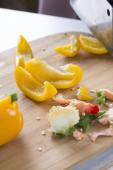 Cut vegetables on a wooden board. Red and yellow peppers, Broccoli.
