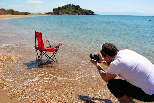 a photographer on the beach taking stock pictures