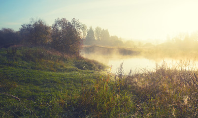 Fototapeta na wymiar Foggy autumn landscape with river