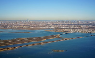 Aerial view of the Manhattan skyline in New York City seen from an airplane in approach for landing...