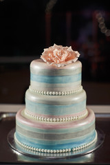 Stunning wedding cake covered with shiny icing and pearls