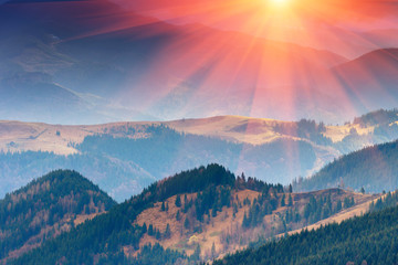 Wonderful landscape  of mountains in spring. View of the hills covered with forest in the rays of sunlight.