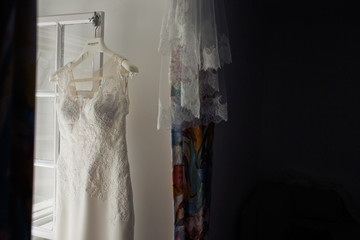 Wedding dress hangs on the window