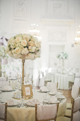 Rich white bouquet stands in the middle of dinner table number 6