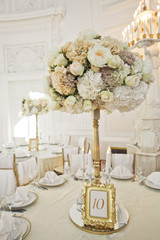 Number 10 put in frame stands beneath bouquet on the table