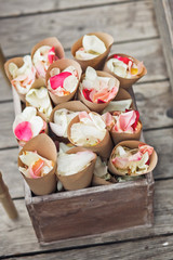 Envelopes with rose petals put in wooden box