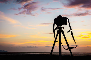 Camera and tripod on the sunset