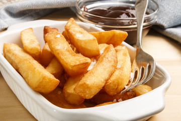 french fries with british brown sauce in a bowl