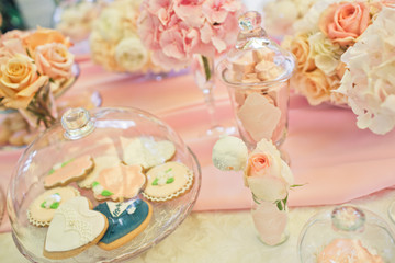Delicious bakery covered with pink glaze stands under glass cover