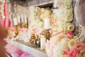 Garlands of hydrangeas and roses hang from the fireplace