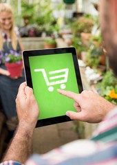 Person using Tablet with Shopping trolley icon