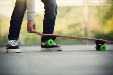 Fototapeta na wymiar skateboarder legs skateboarding at skatepark